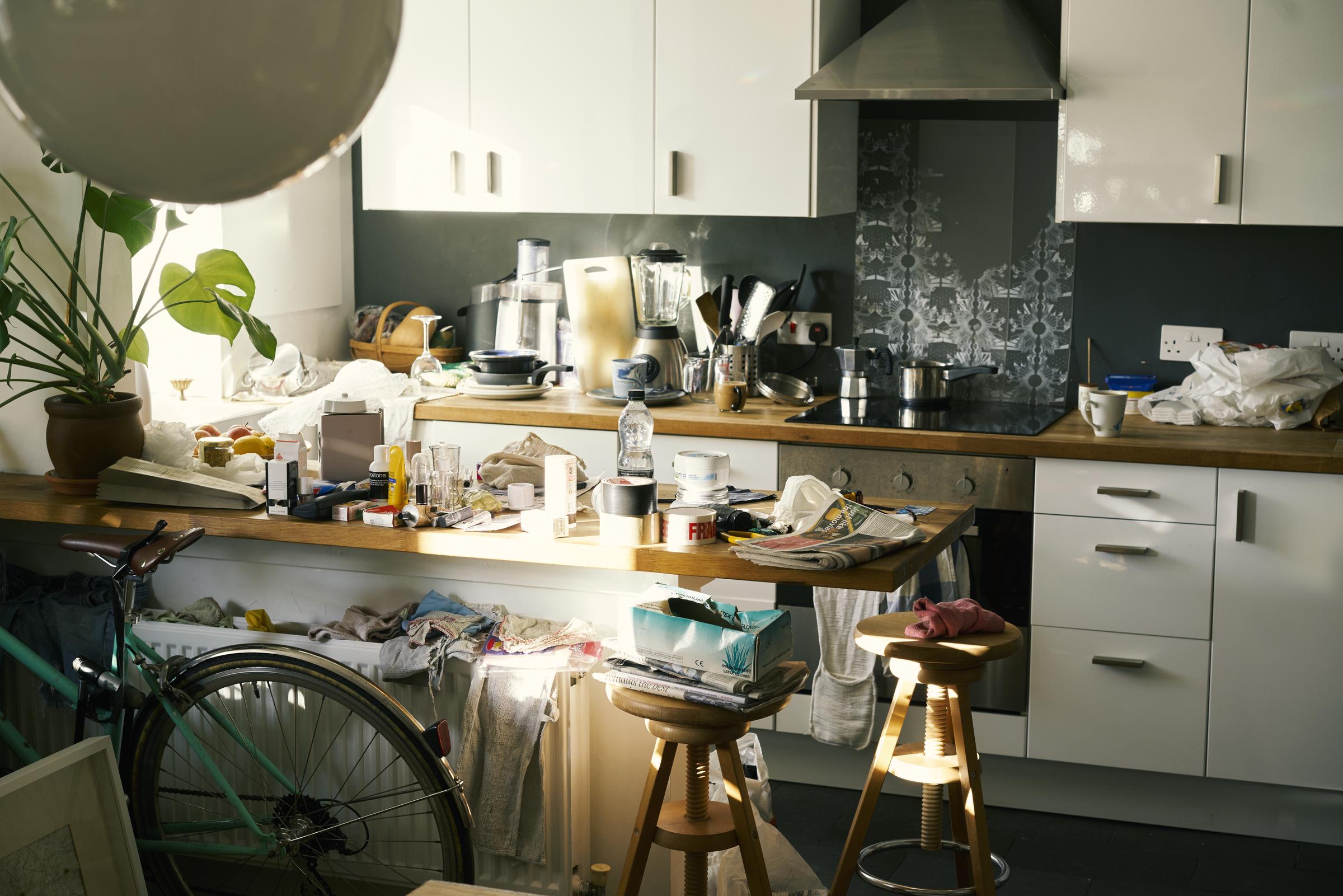 Messy apartment counter tops covered in clutter | Source: Getty Images
