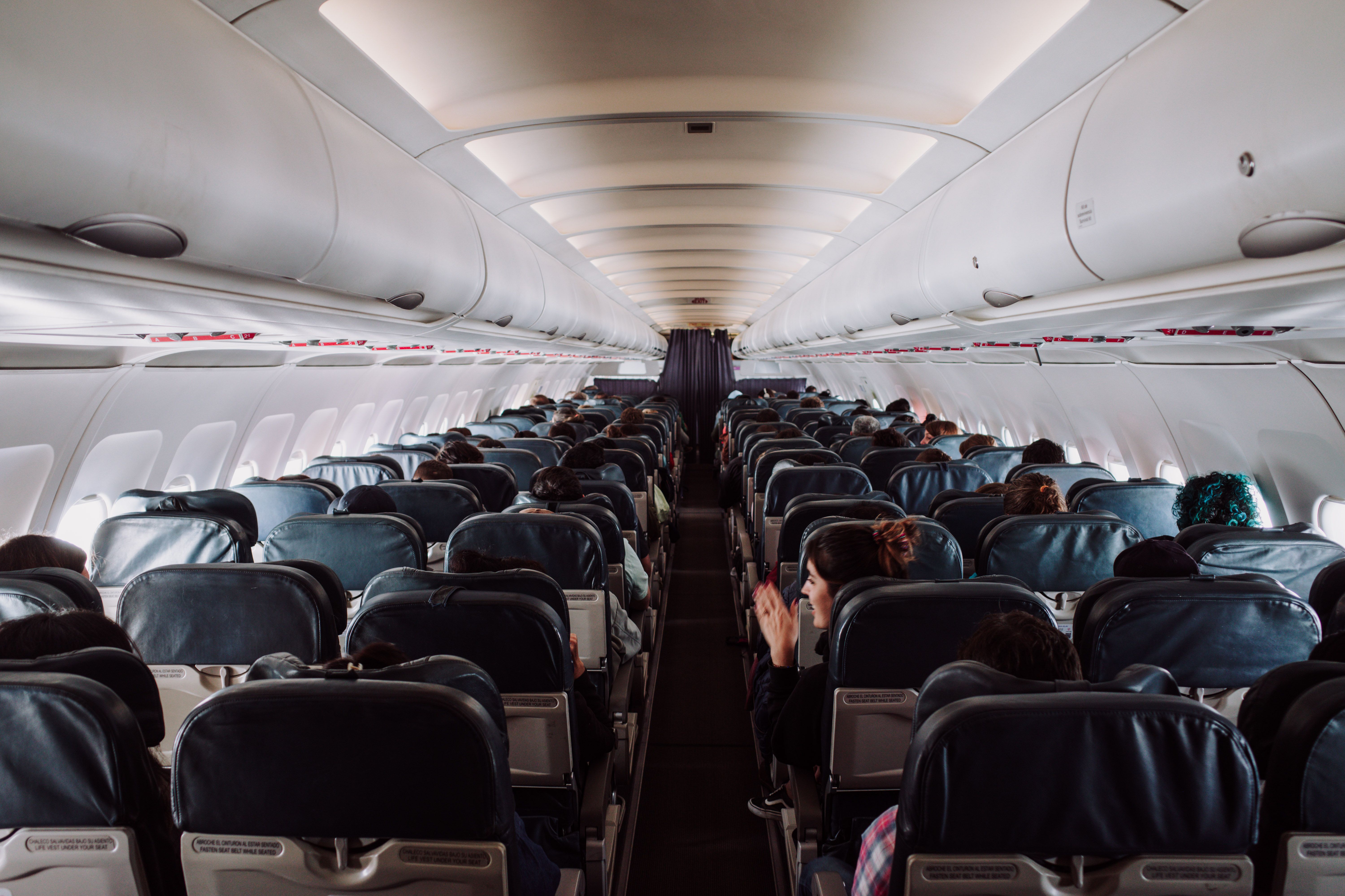 Passengers seated in the economy section of a commercial flight | Source: Pexels