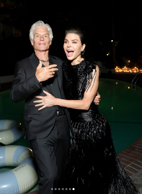 Lisa Rinna and Harry Hamlin share a playful moment beside the pool at The Hollywood Reporter x SAG-AFTRA Emmy Nominees Night, with Rinna striking an animated pose in her dramatic black fringe gown. | Source: Instagram/lisarinna