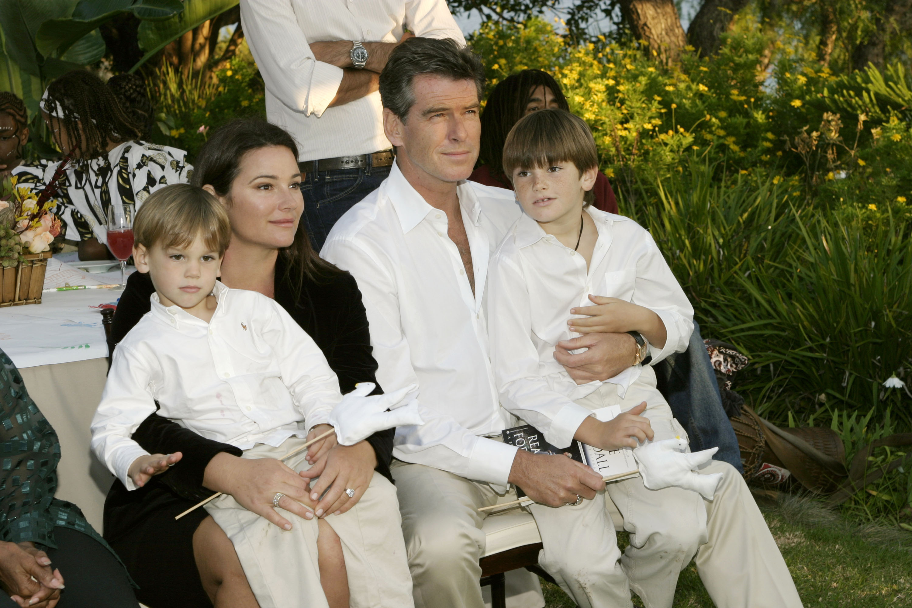 Long before their latest Hollywood outing, Pierce Brosnan and Keely Shaye Smith were photographed with their sons, Paris and Dylan, during a family appearance. The image captures the brothers as children alongside their parents. | Source: Getty Images