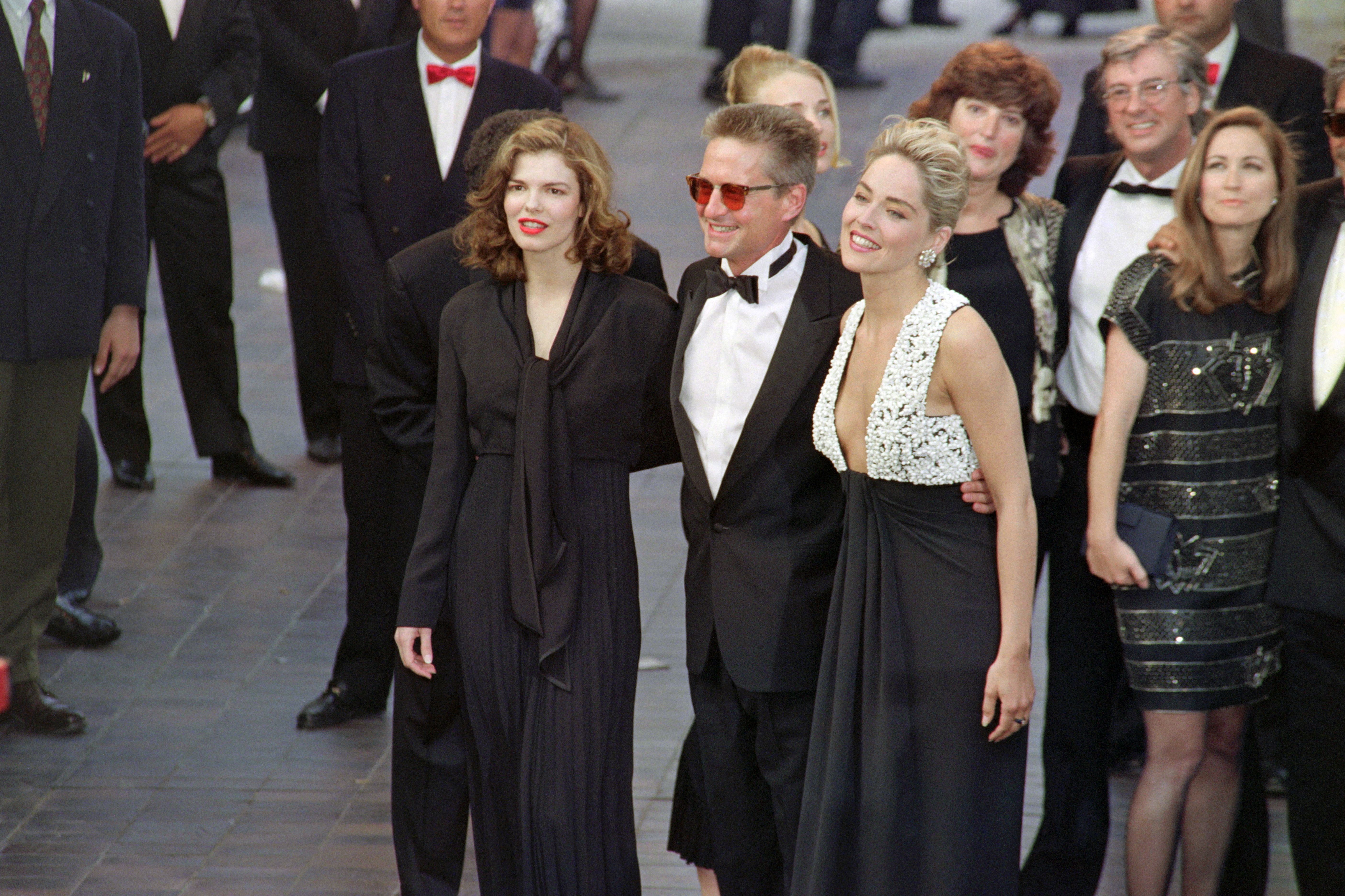 Sharon Stone, Michael Douglas and Jeanne Tripplehorn arrive for the opening ceremony of the 45th Cannes Film Festival in Cannes, France, on May 7, 1992. Douglas later said he contacted Tripplehorn before including their past relationship in his memoir and received her permission to tell the story. | Source: Getty Images