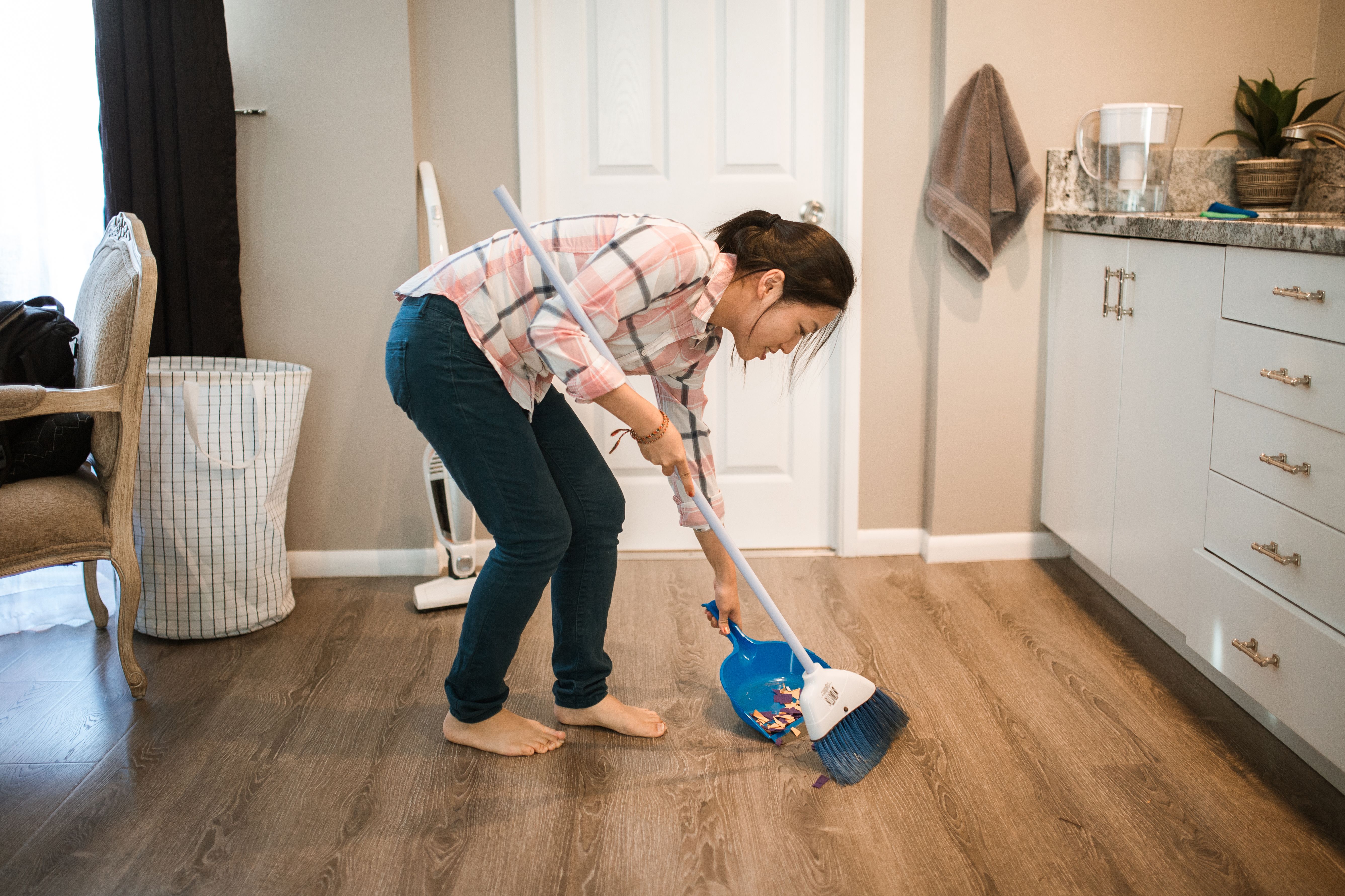 A person sweeping the floor | Source: Pexels
