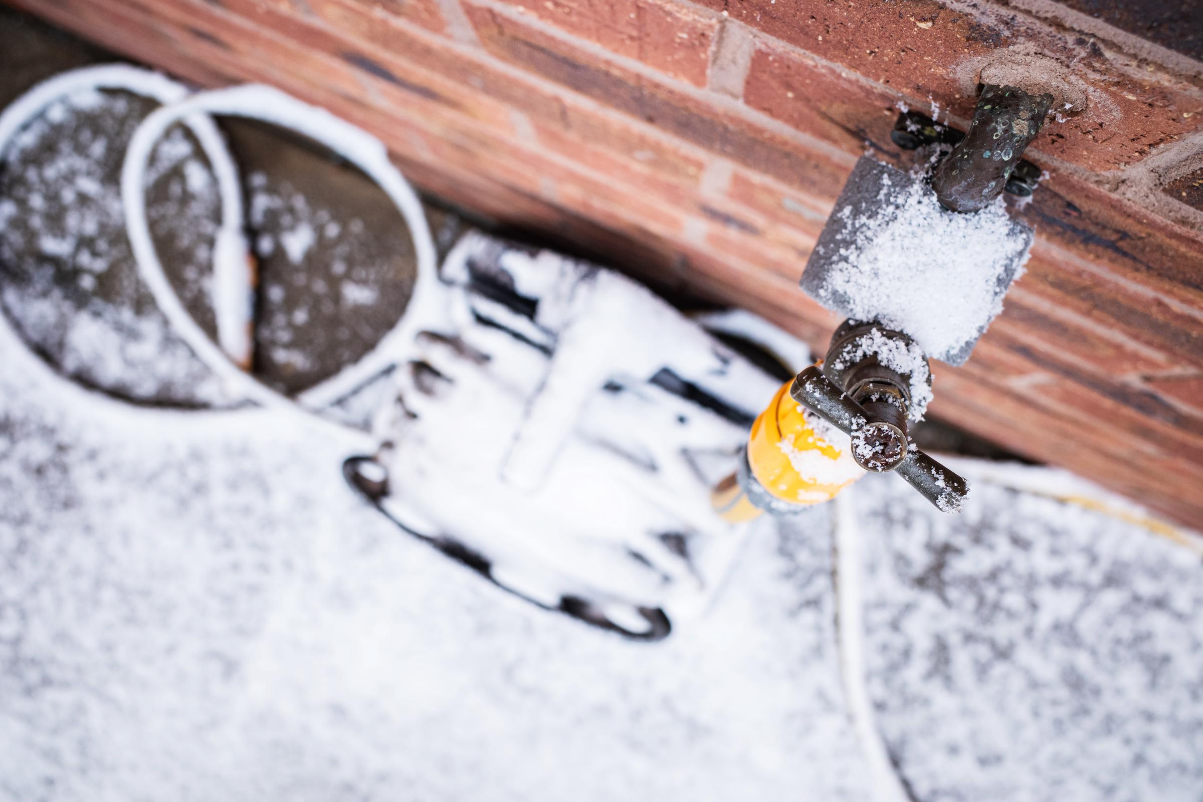 An outside tap and hosepipe reel in winter | Source: Getty Images