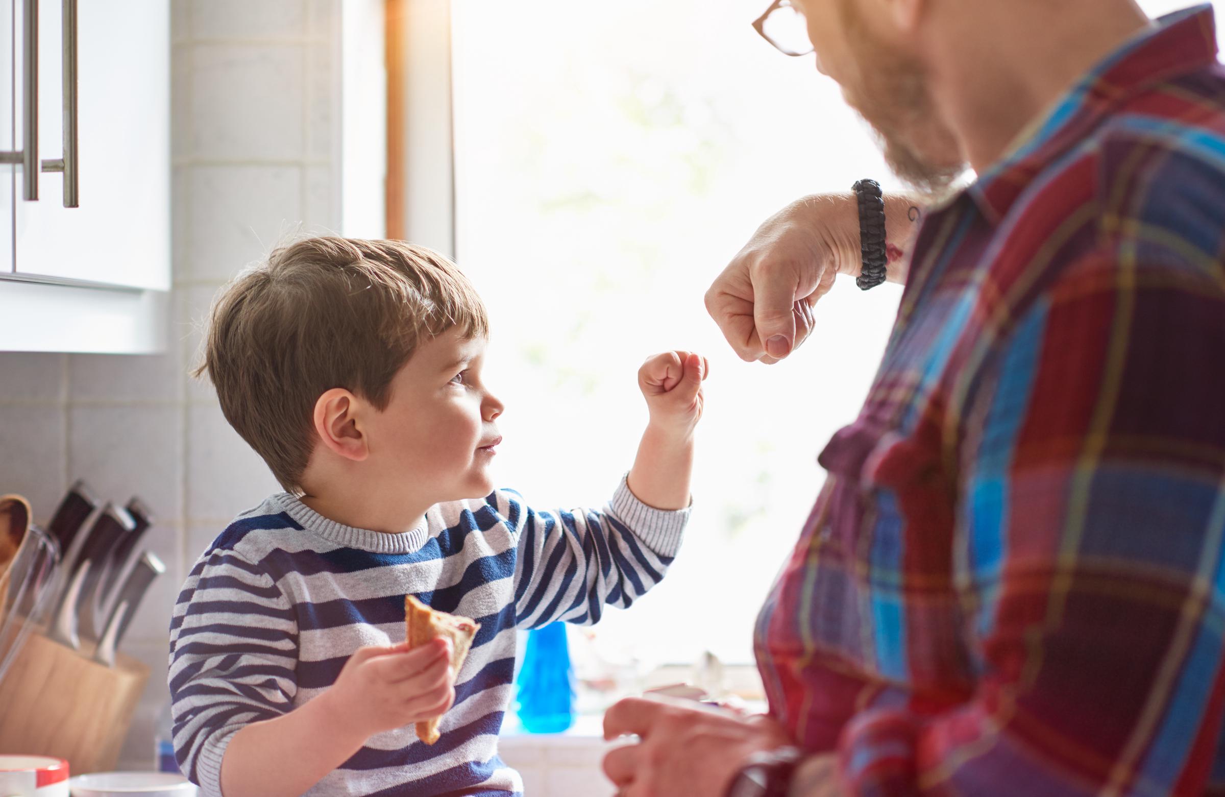 A father and son doing a fist bump | Source: Getty Images