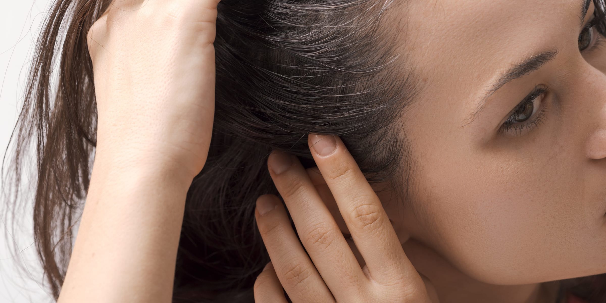 A woman inspecting her scalp | Source: Getty Images