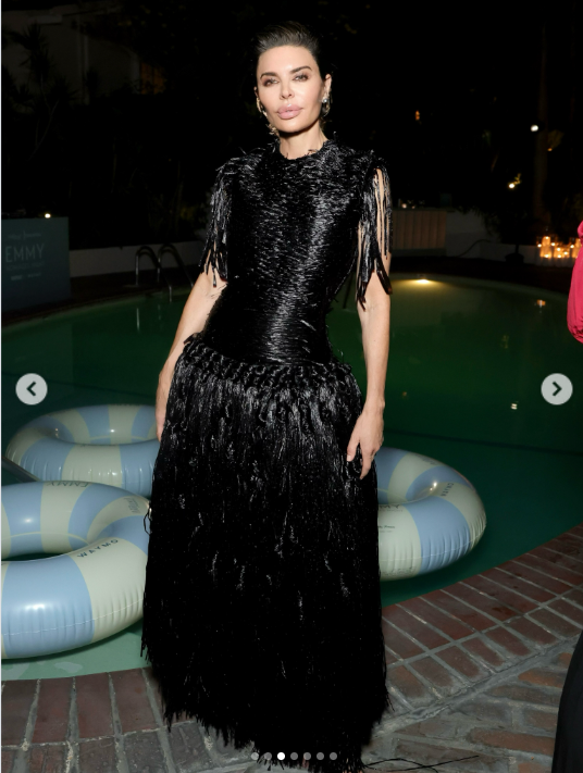 Lisa Rinna poses beside the pool at The Hollywood Reporter x SAG-AFTRA Emmy Nominees Night, showcasing the textured bodice and cascading fringe of her dramatic black Antonio Grimaldi couture gown. | Source: Instagram/lisarinna