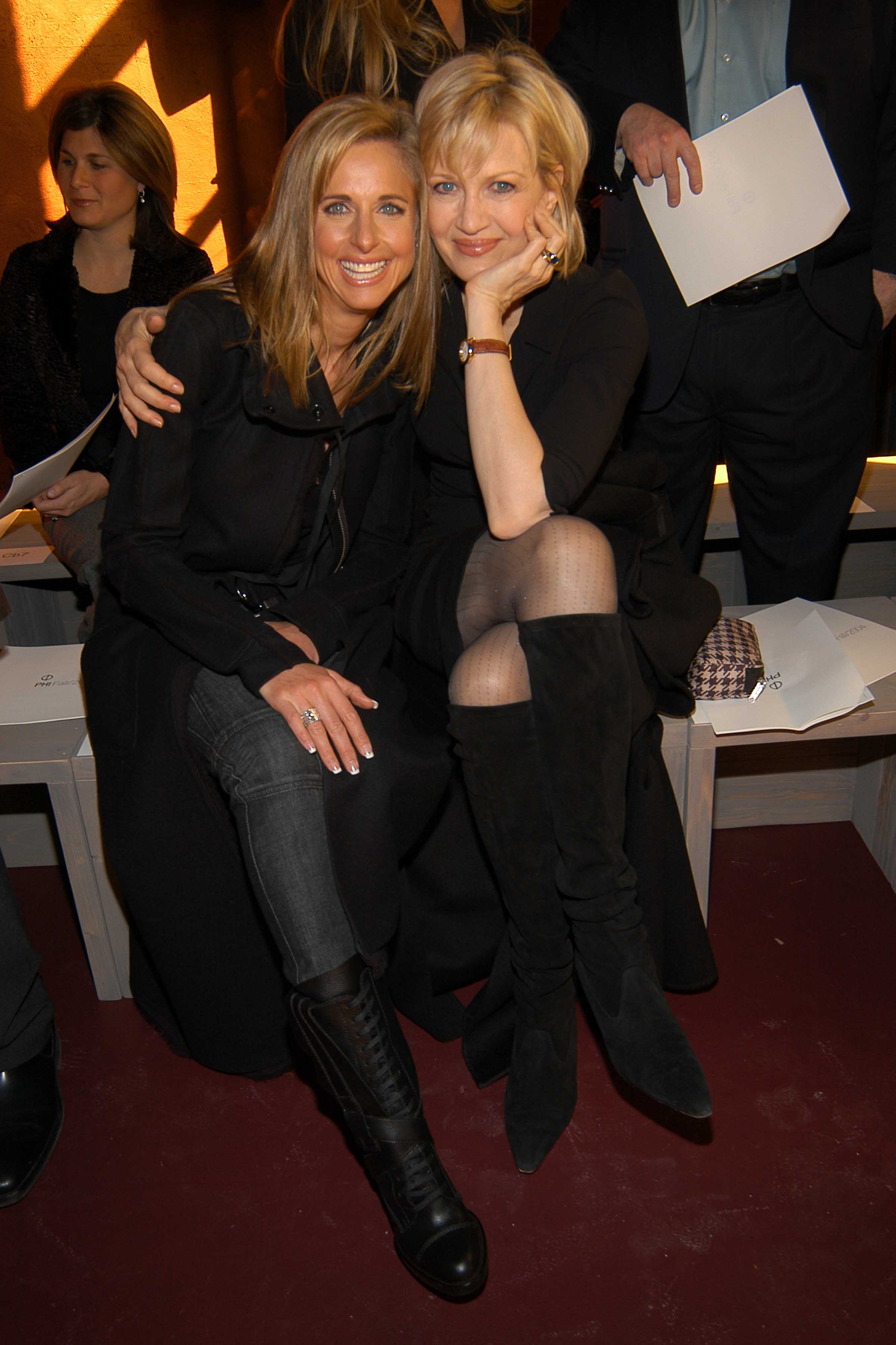 Susan Dell and Diane Sawyer sat close together and smiled warmly from the front row of the Phi Fall 2004 Fashion show in New York on February 13, 2004. Both opted for chic, monochromatic black ensembles, with Susan wearing a tailored dark coat over trousers paired with lace-up leather boots, while Diane posed beside her in a black dress, sheer hosiery, and knee-high suede boots. | Source: Getty Images