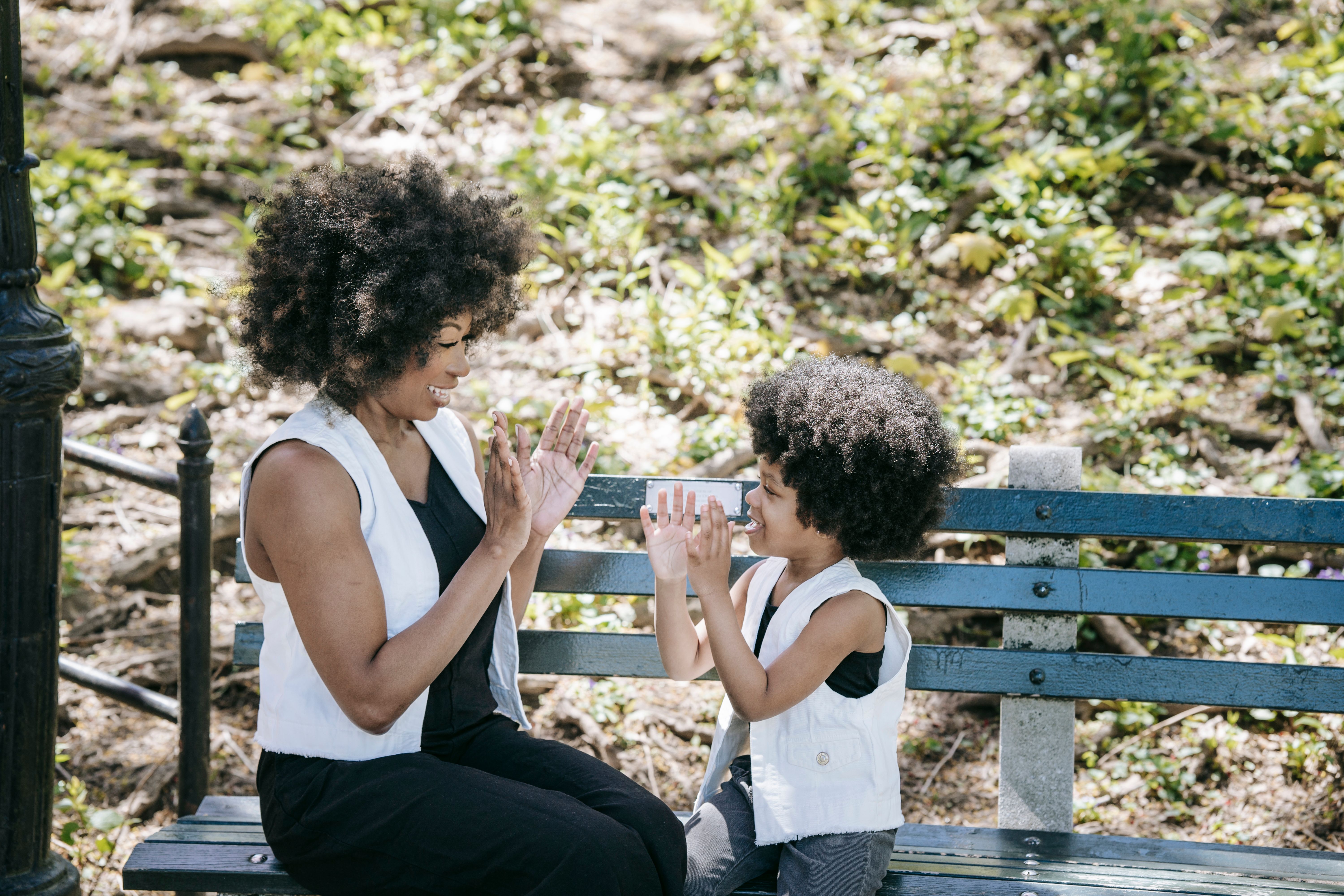 Mother and child in matching outfits playing outdoors | Source: Pexels