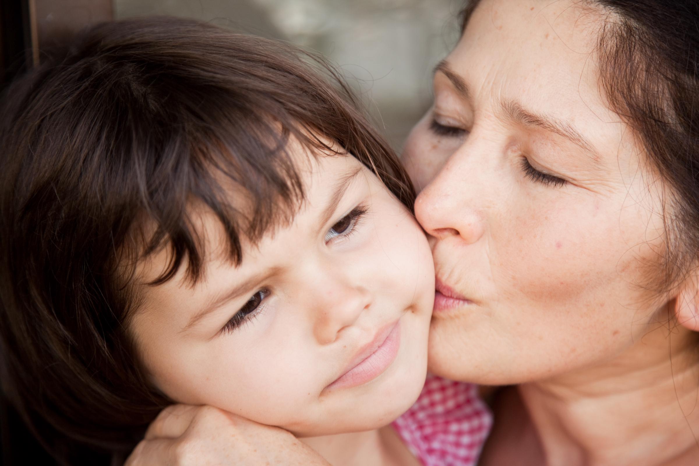 A grandmother kissing her granddaughter | Source: Getty Images