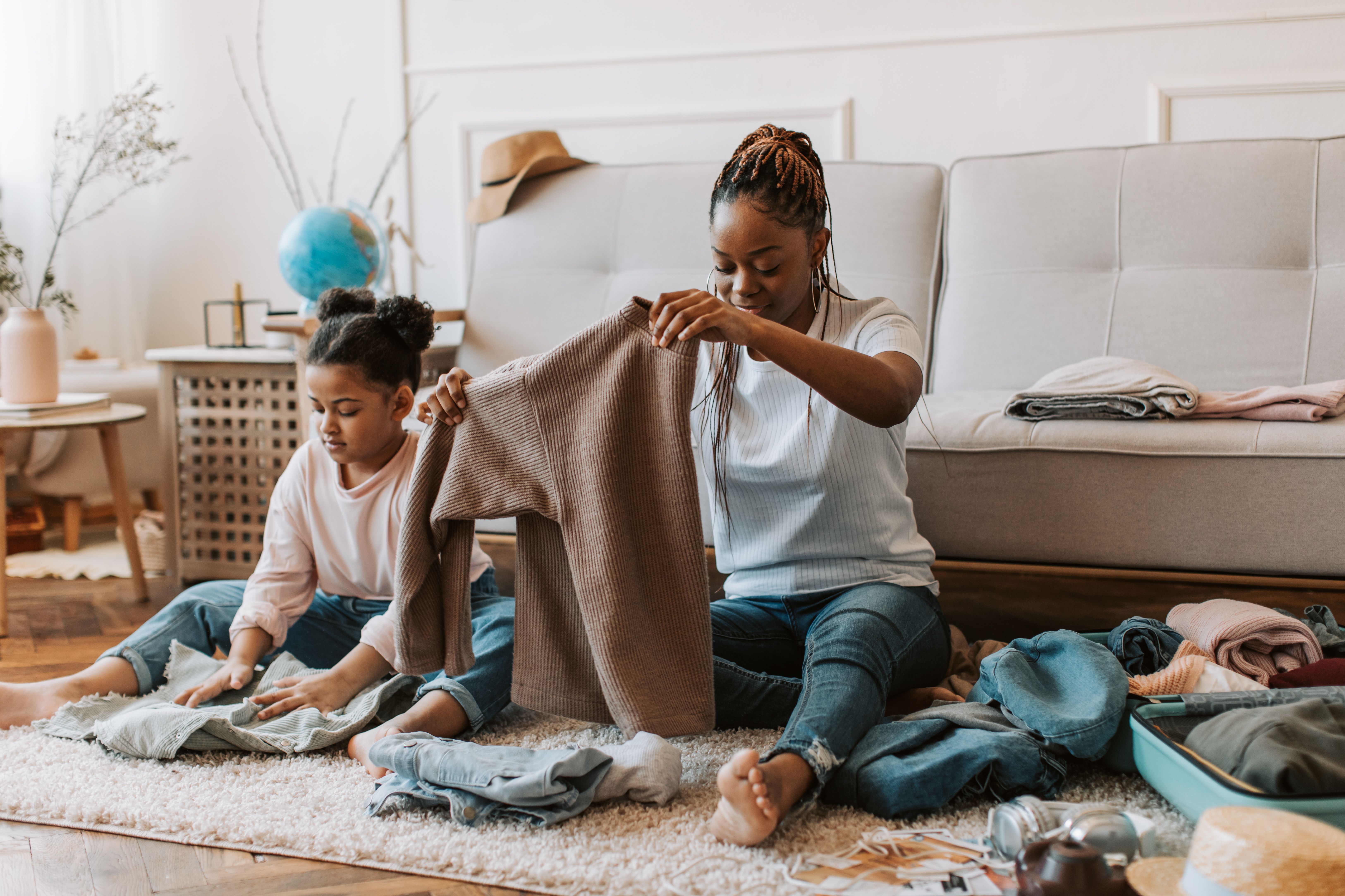 A child helping her mother fold clothes | Source: Pexels