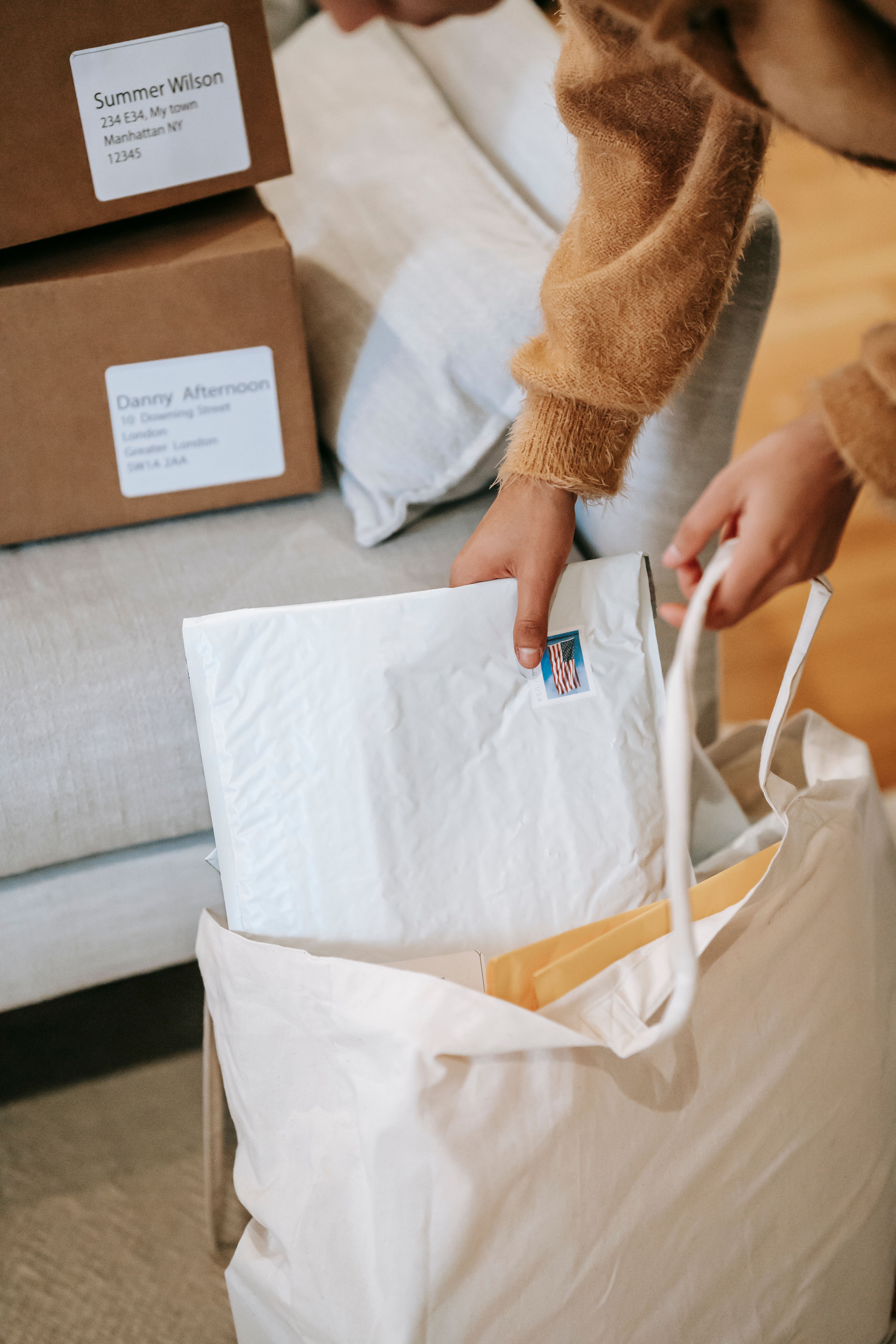 Person storing mail in a bag | Source: Pexels