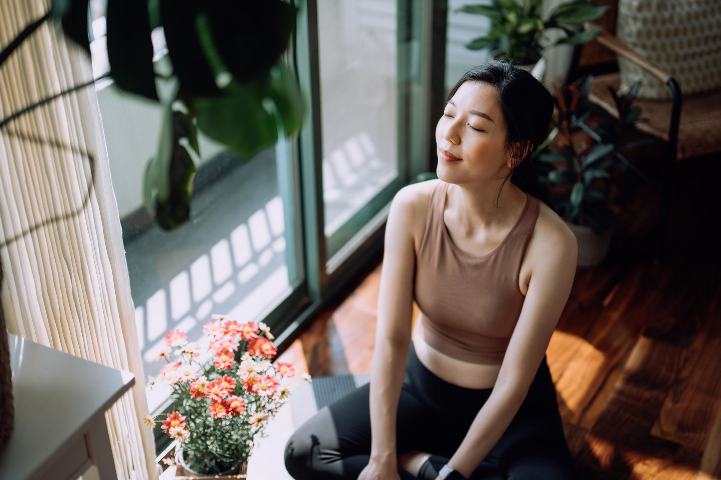 A woman taking a break after working out at home | Source: Getty Images