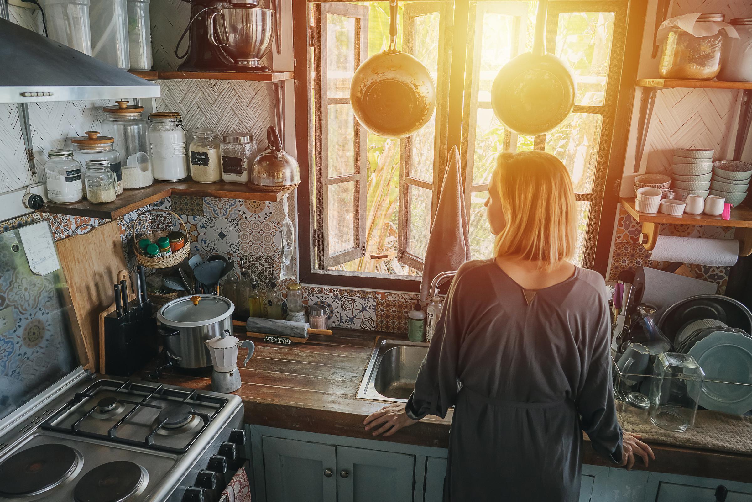 A woman standing in her kitchen | Source: Getty Images