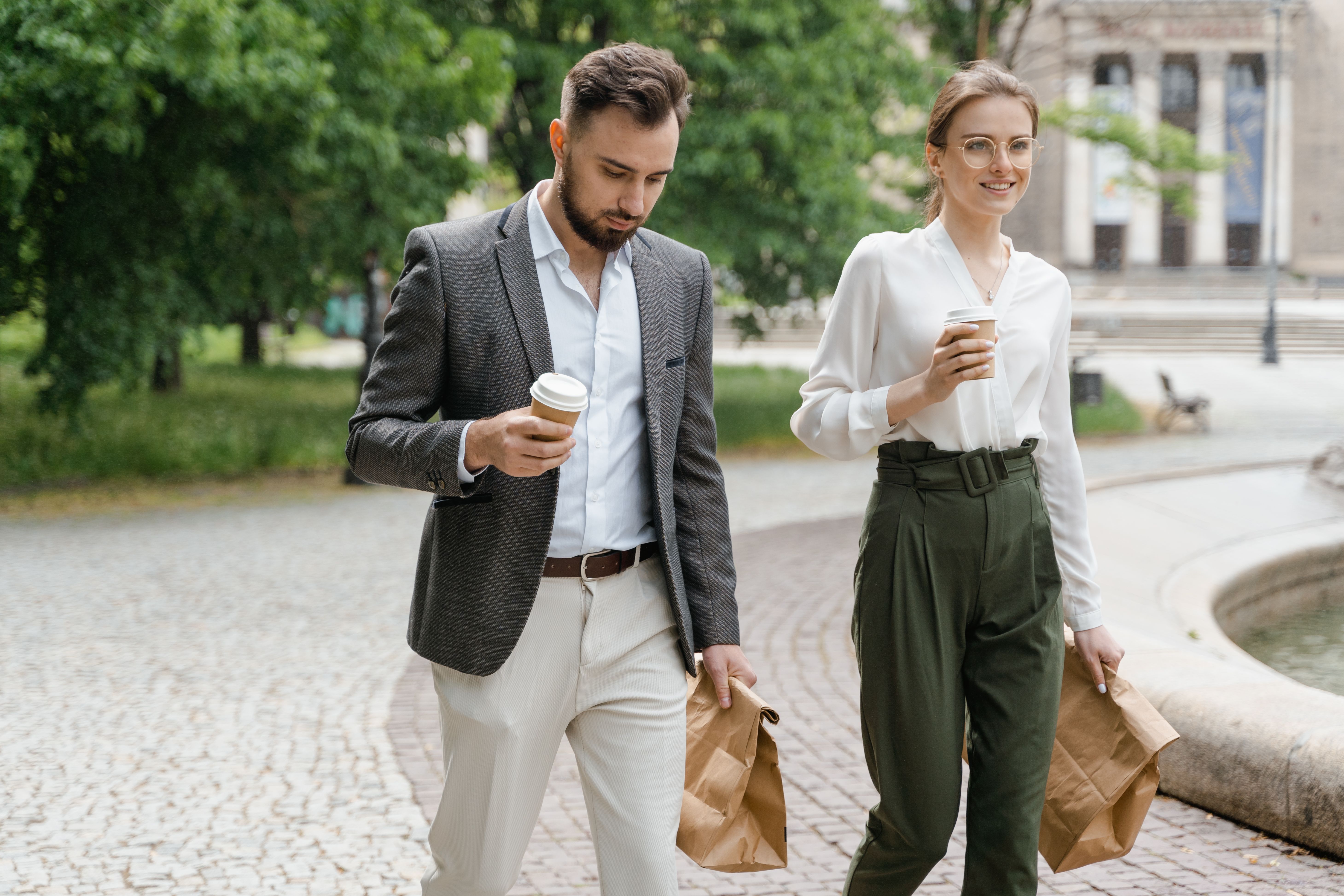 A man and a woman walking during a coffee break | Source: Pexels