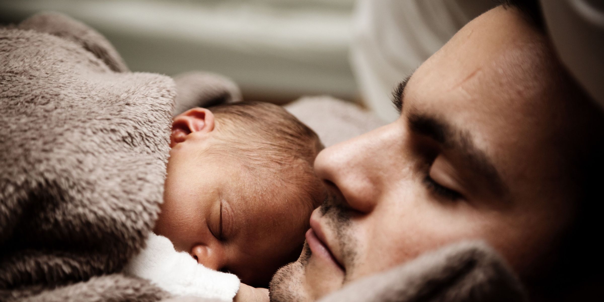 A father holding his newborn | Source: Pexels