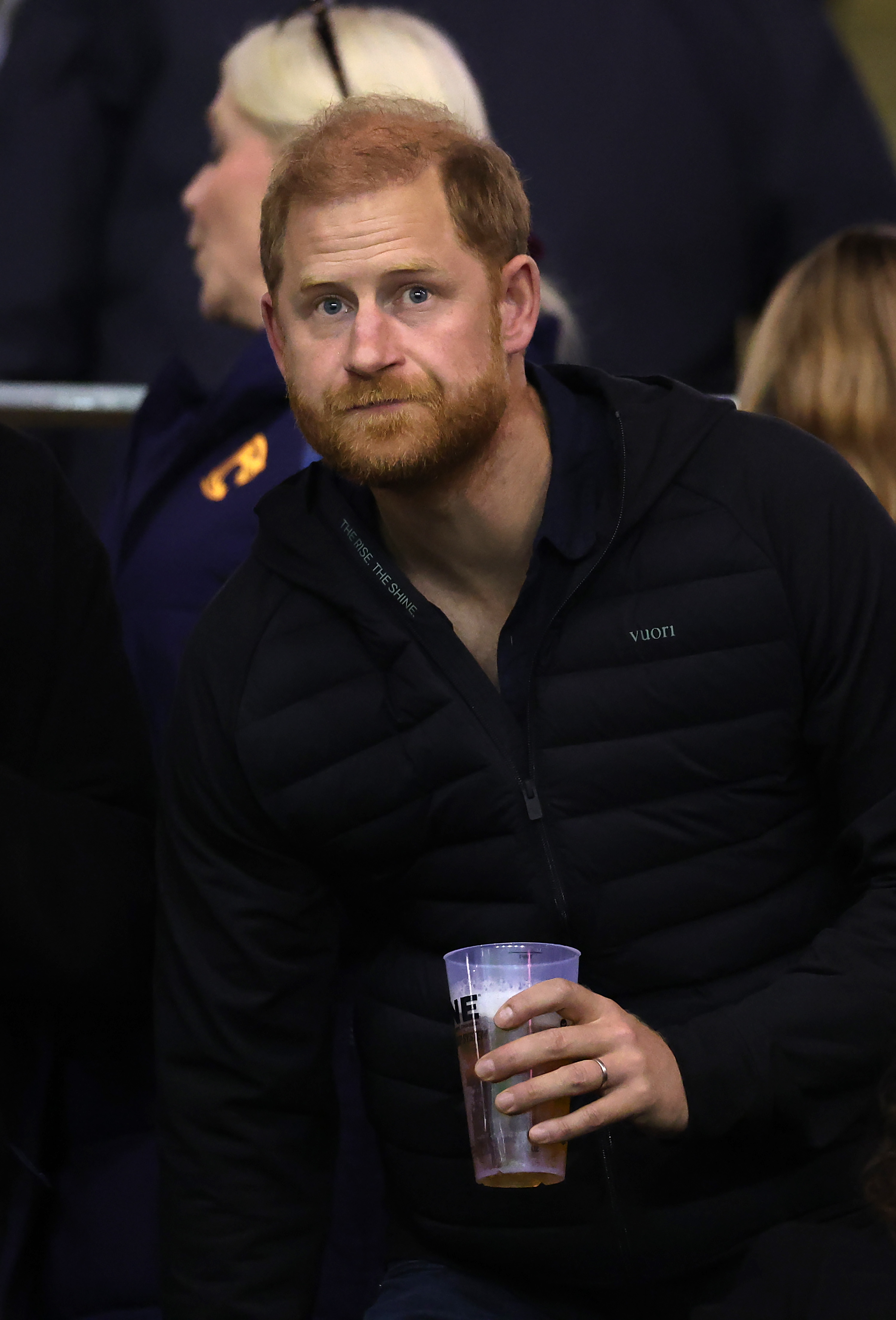 Prince Harry holds a plastic cup while watching the match from the stands at Leicester's Welford Road Stadium, moments captured during his October 9, 2026, outing. | Source: Getty Images