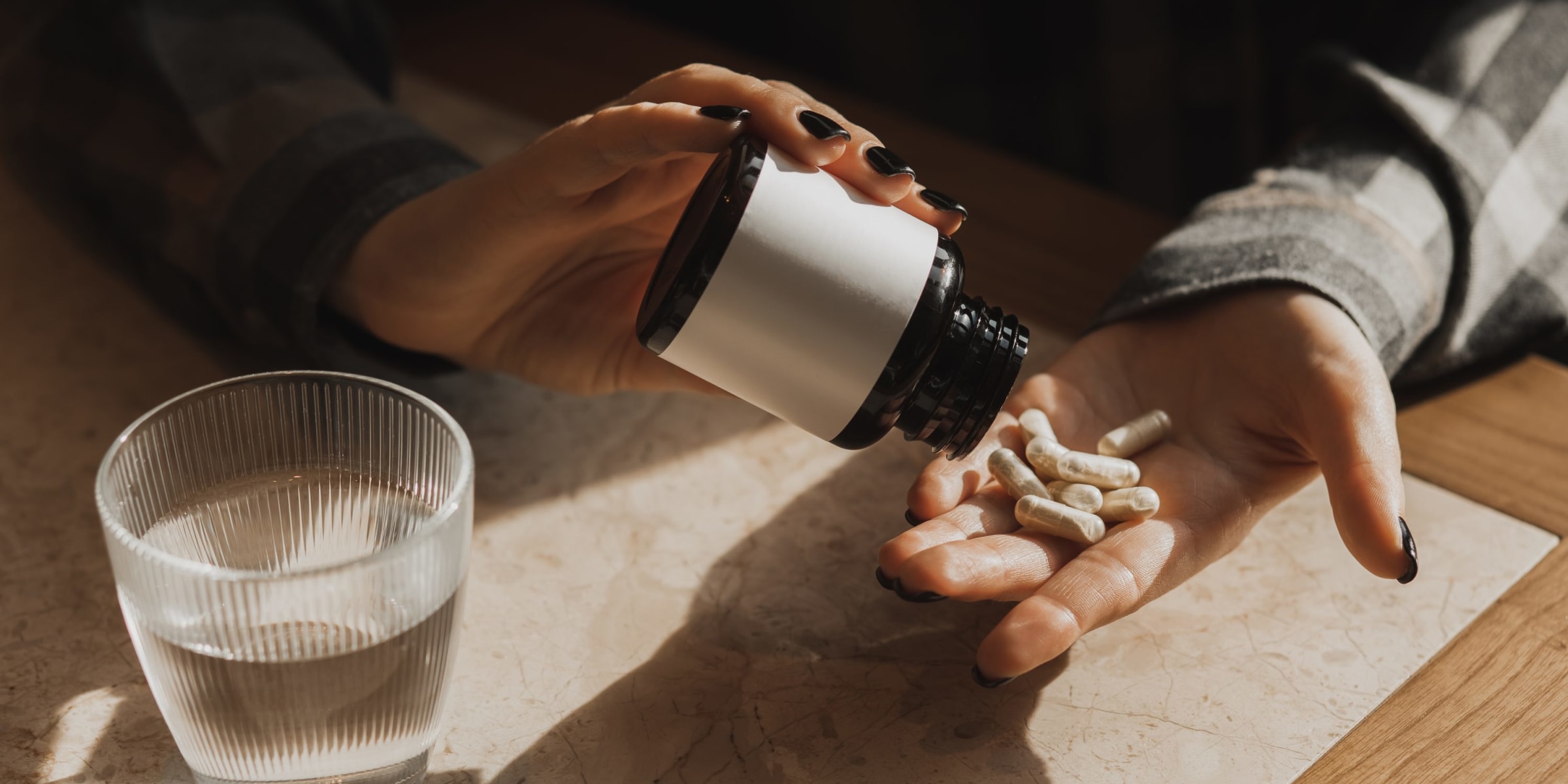 A woman taking magnesium capsule supplements | Source: Getty Images