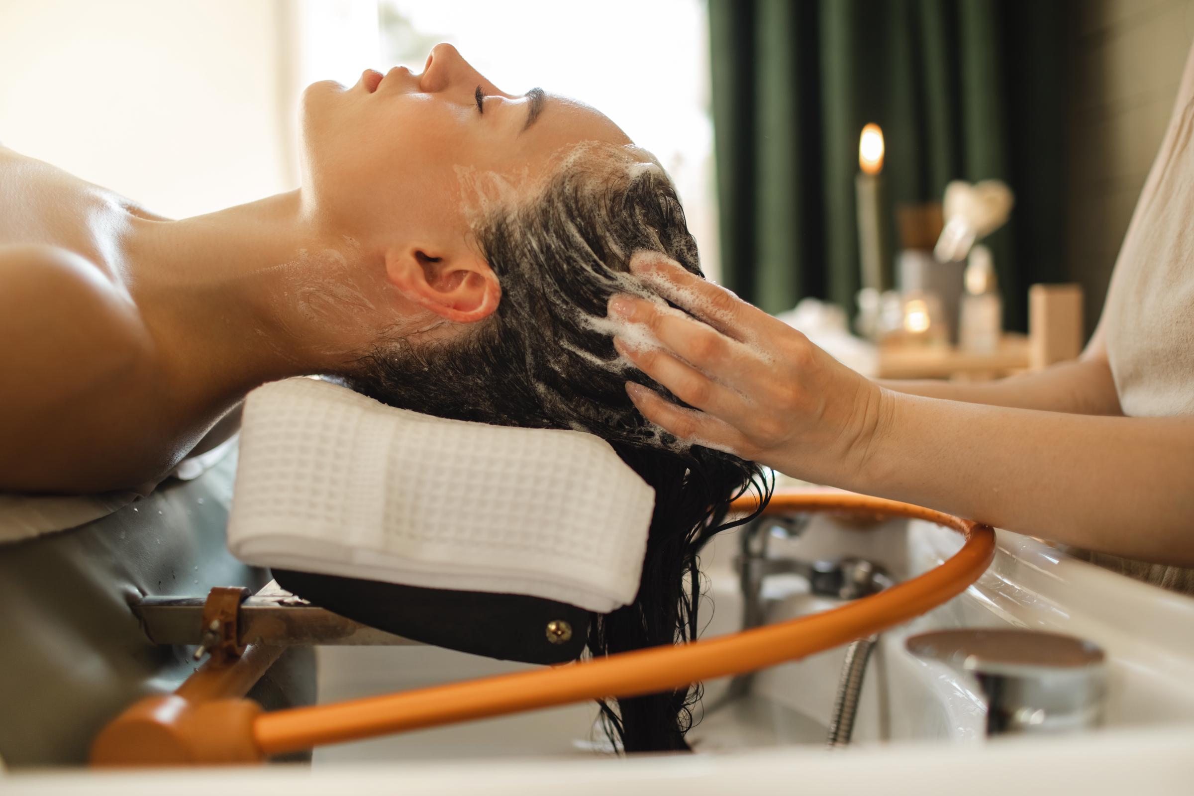 A woman getting her hair washed professionally | Source: Getty Images