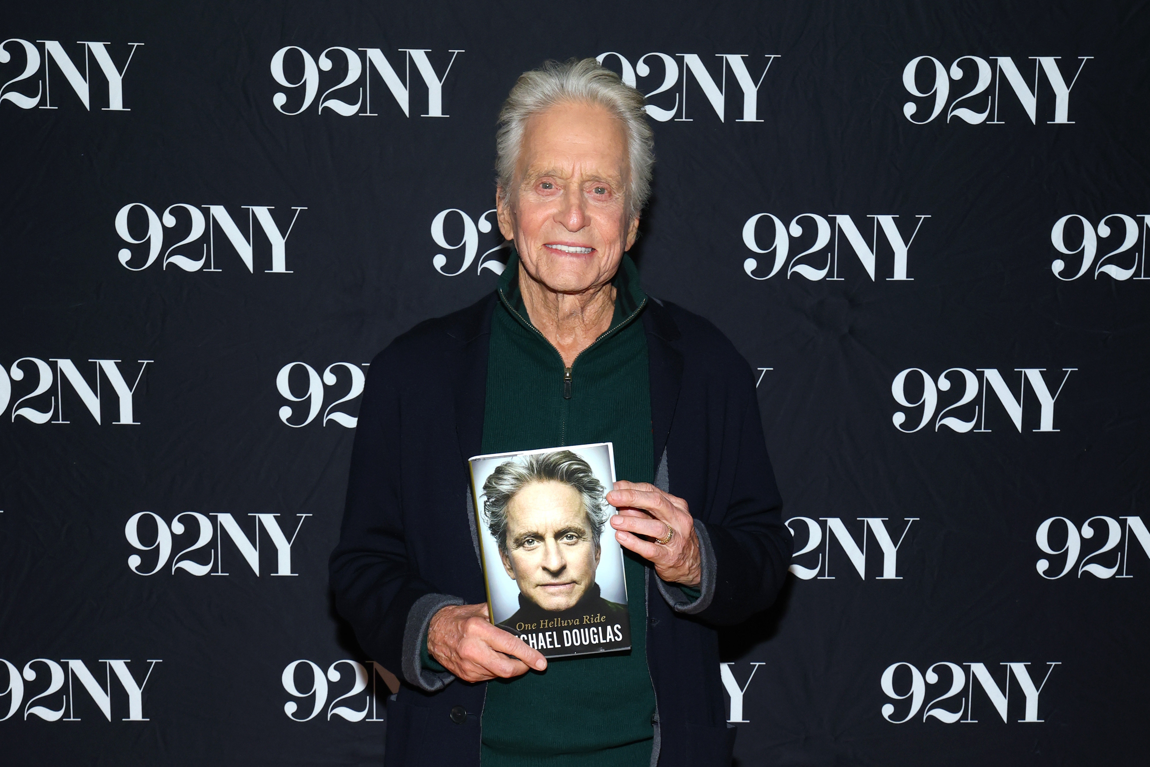Michael Douglas posed with his memoir, One Helluva Ride, after its release, revisiting personal chapters from his decades-long Hollywood career. The book includes his account of a romance that began while he was filming the 1992 thriller Basic Instinct. | Source: Getty Images