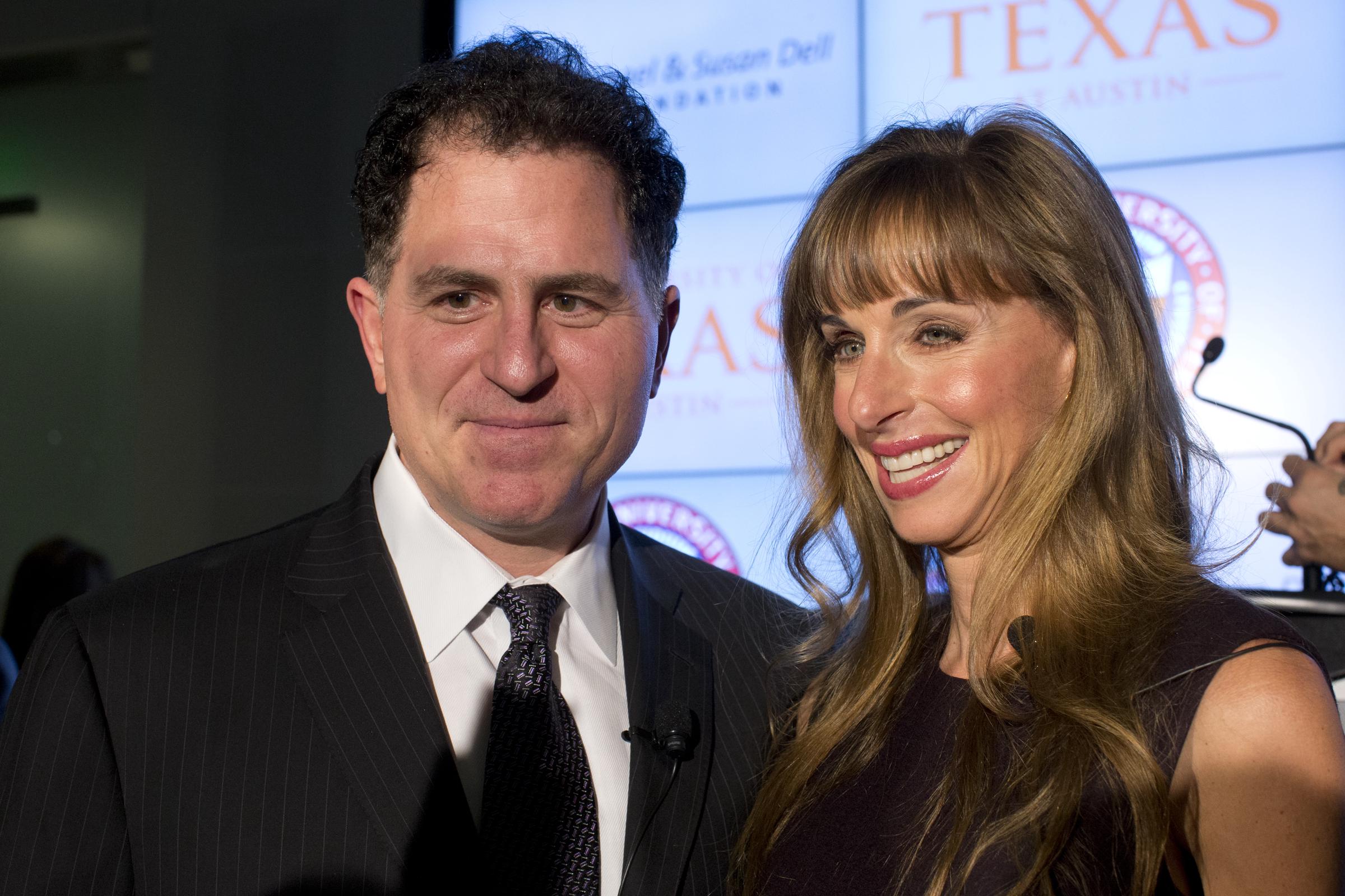 Dell Computer CEO Michael Dell and his wife, Susan, posed together with bright smiles on January 30, 2013, to announce a $50 million donation over 10 years to the University of Texas at Austin for the creation of the Dell Medical School. Michael looked sharp in a pinstripe black suit, white dress shirt, and dark patterned necktie, while Susan smiled warmly beside him in a sleeveless dark dress, her wavy hair falling over her shoulders with neat front bangs. | Source: Getty Images