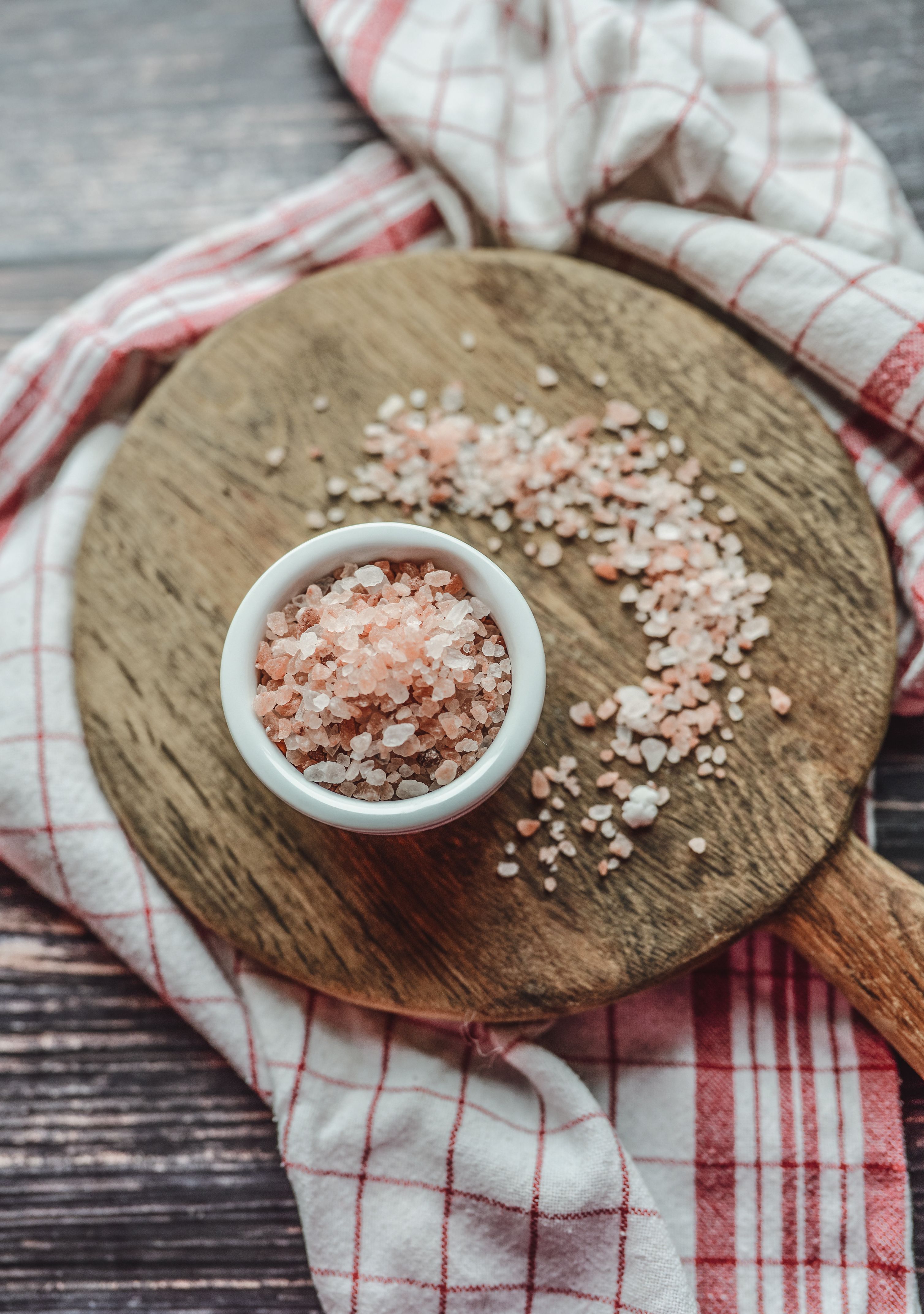 Pink Himalayan salt displayed on a wooden board | Source: Pexels