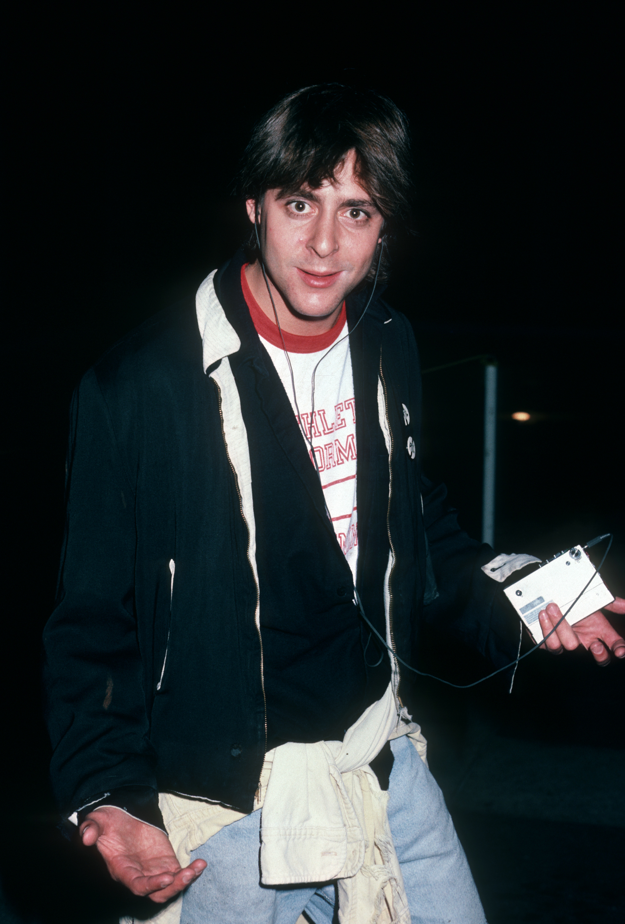 Nelson arrived at The Breakfast Club premiere in 1985 with headphones in and a portable cassette player in hand — a tiny detail that makes this off-screen moment feel almost as unmistakably ’80s as Bender himself. | Source: Getty Images
