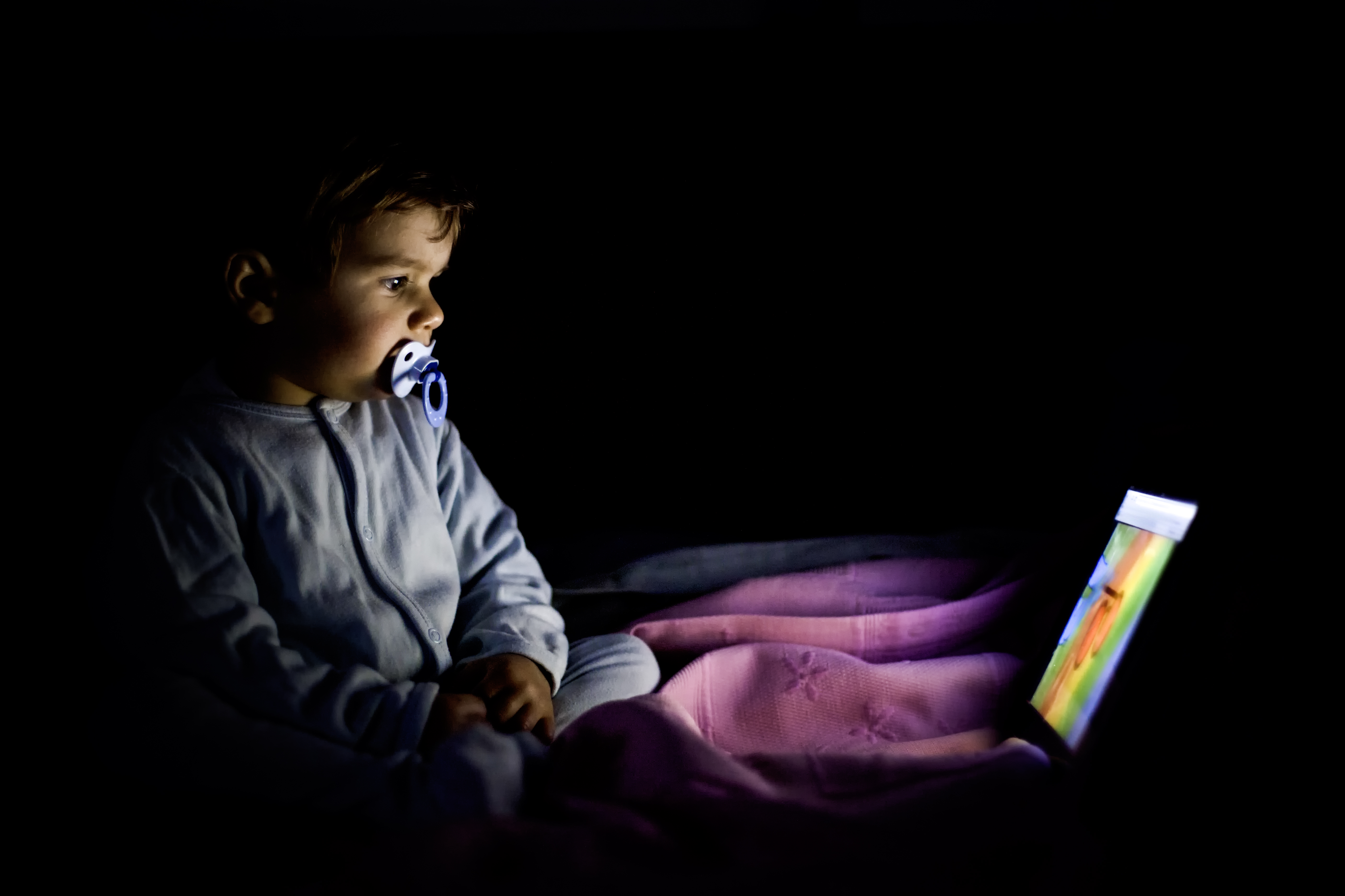 A little boy watching a video on a digital tablet | Source: Getty Images