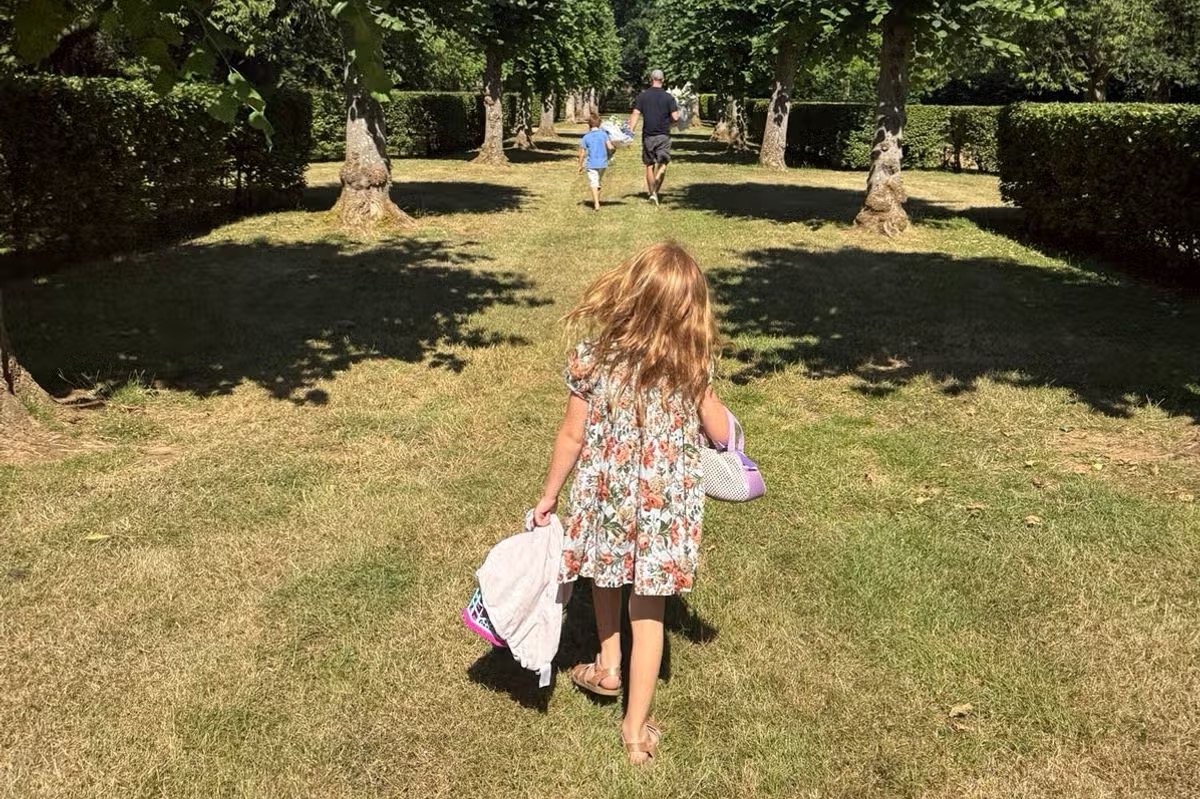 Lilibet is seen walking through the garden from behind, one of the carefully chosen family glimpses Meghan has shared while keeping her daughter’s face out of view. | Source: Meghan Markle’s Instagram Stories