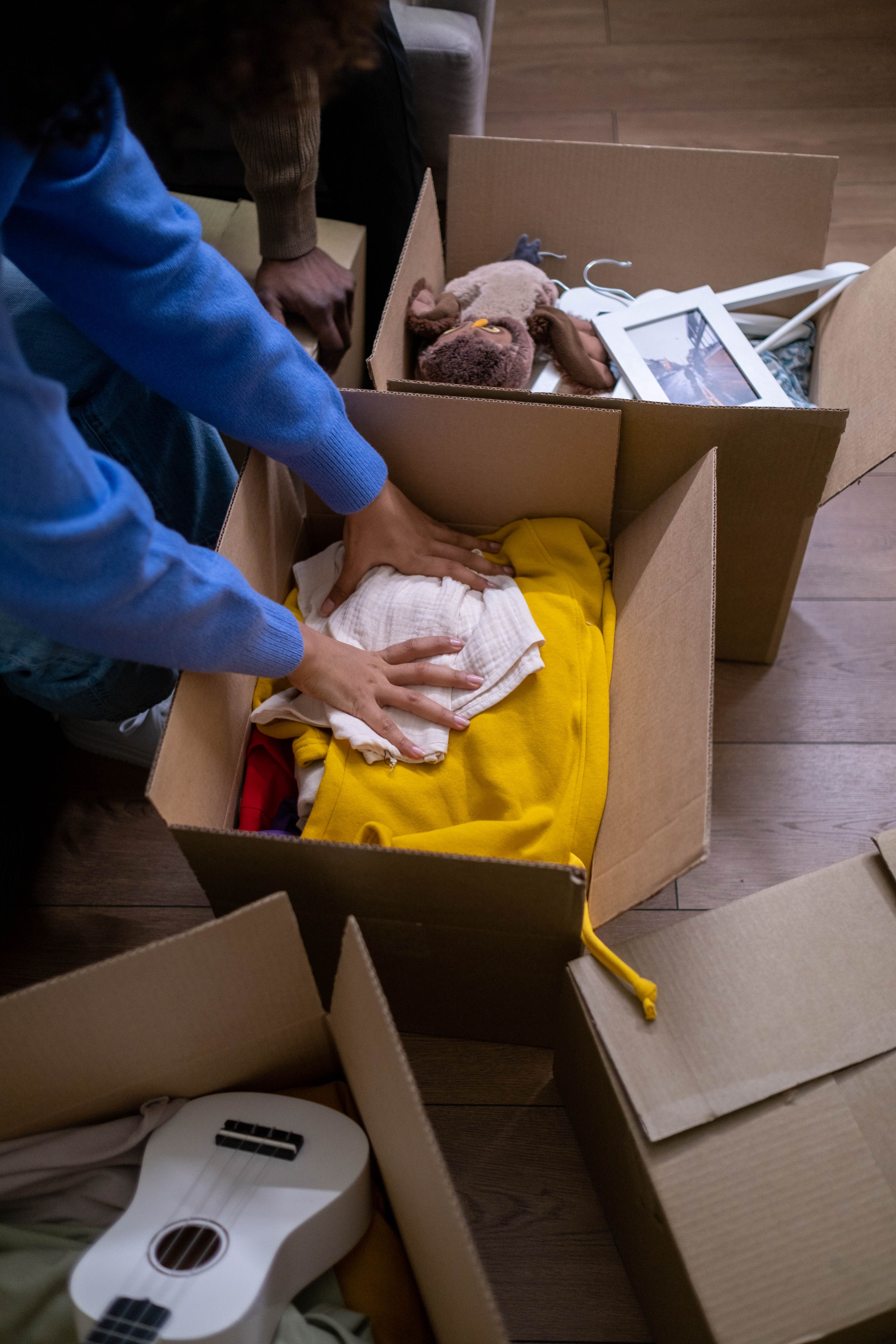 Person storing things in boxes | Source: Pexels