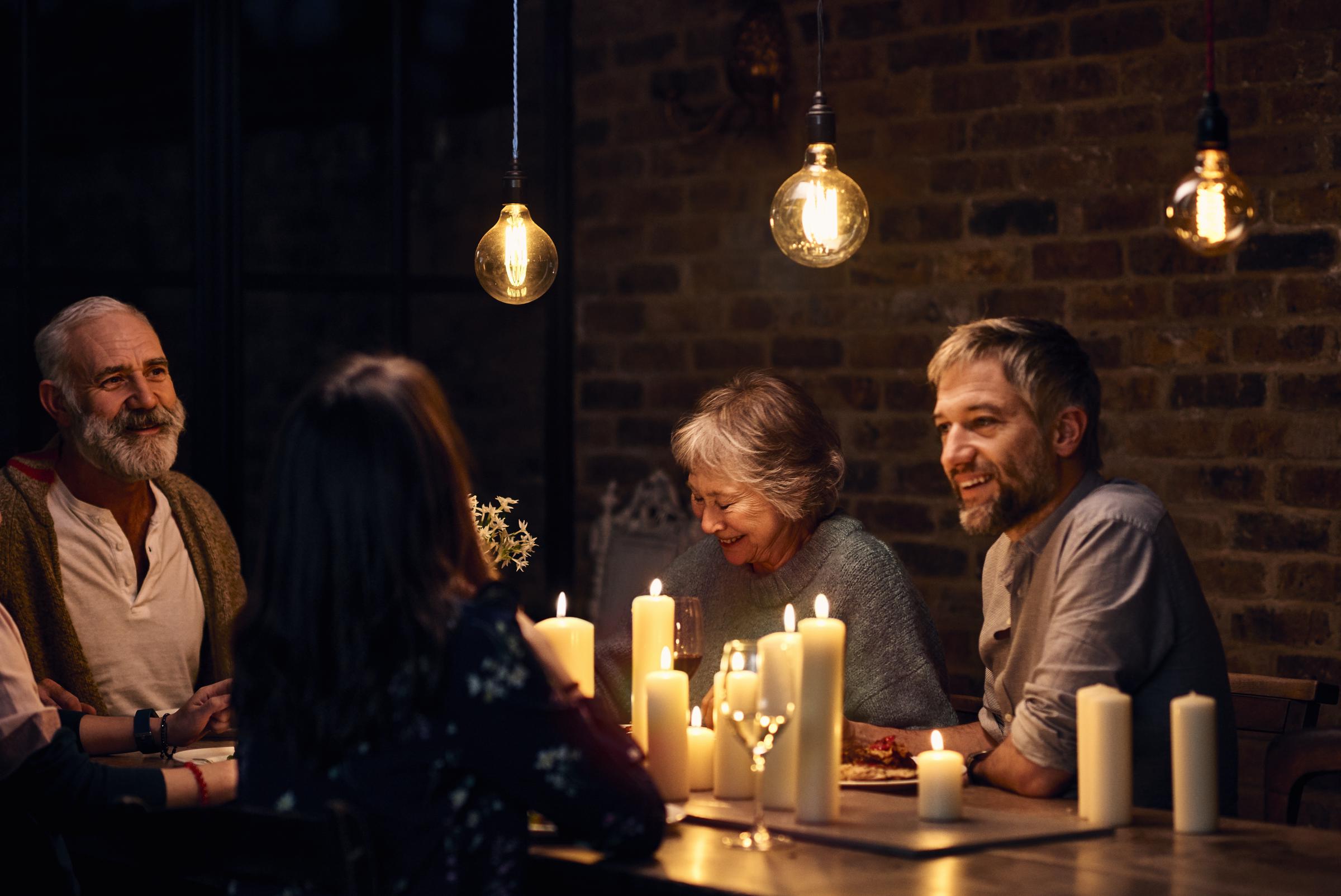 Parents with their adult kids sitting around dining table