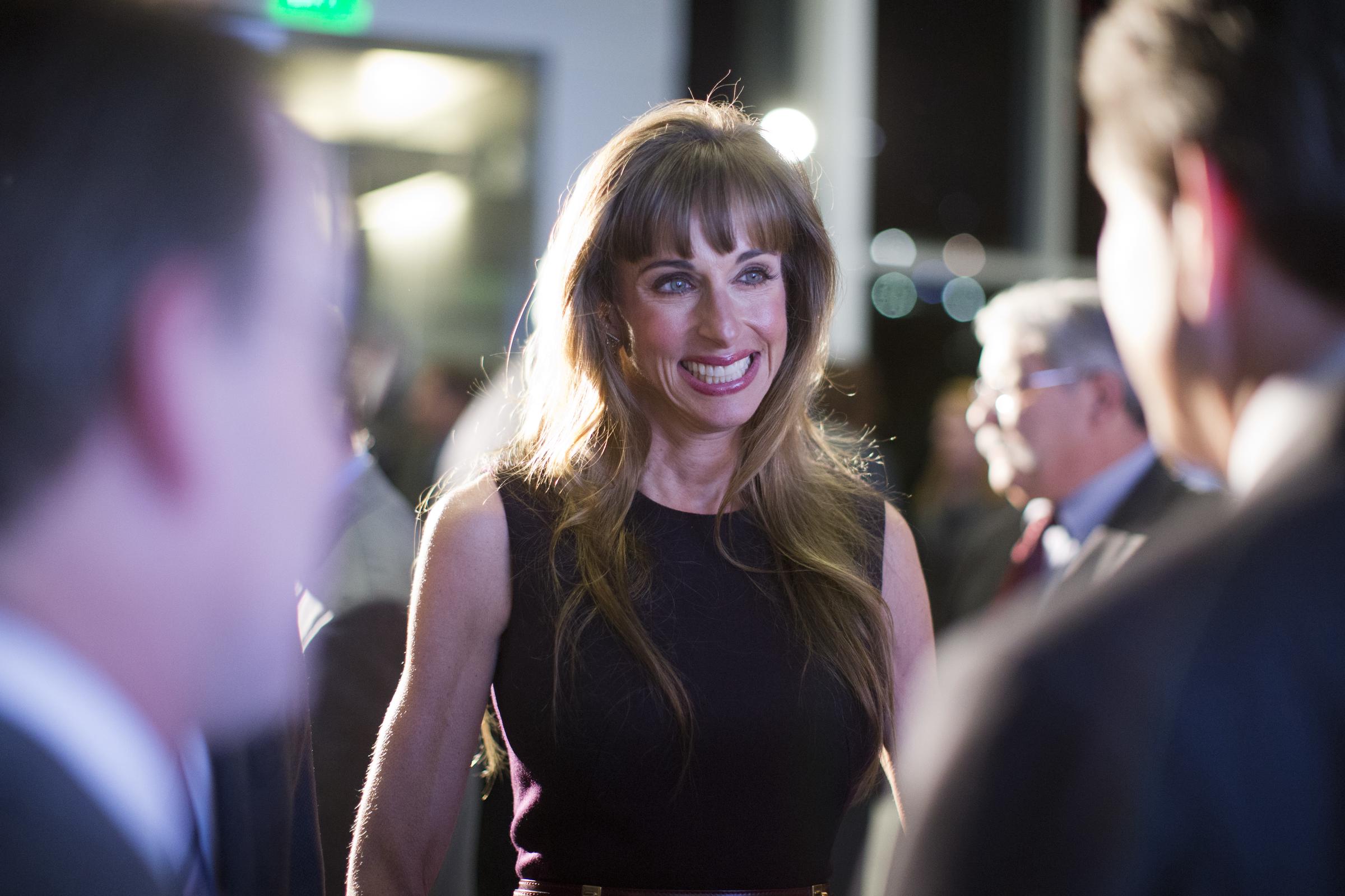 Susan Dell smiled warmly as she mingled with guests during an event announcing a major philanthropic milestone alongside her husband, Dell CEO Michael Dell. She wore a sleeveless, high-neck dark dress, styling her highlighted hair down in soft waves with straight bangs as she conversed with attendees celebrating the $50 million pledge over 10 years to the University of Texas at Austin for the creation of the Dell Medical School. | Source: Getty Images