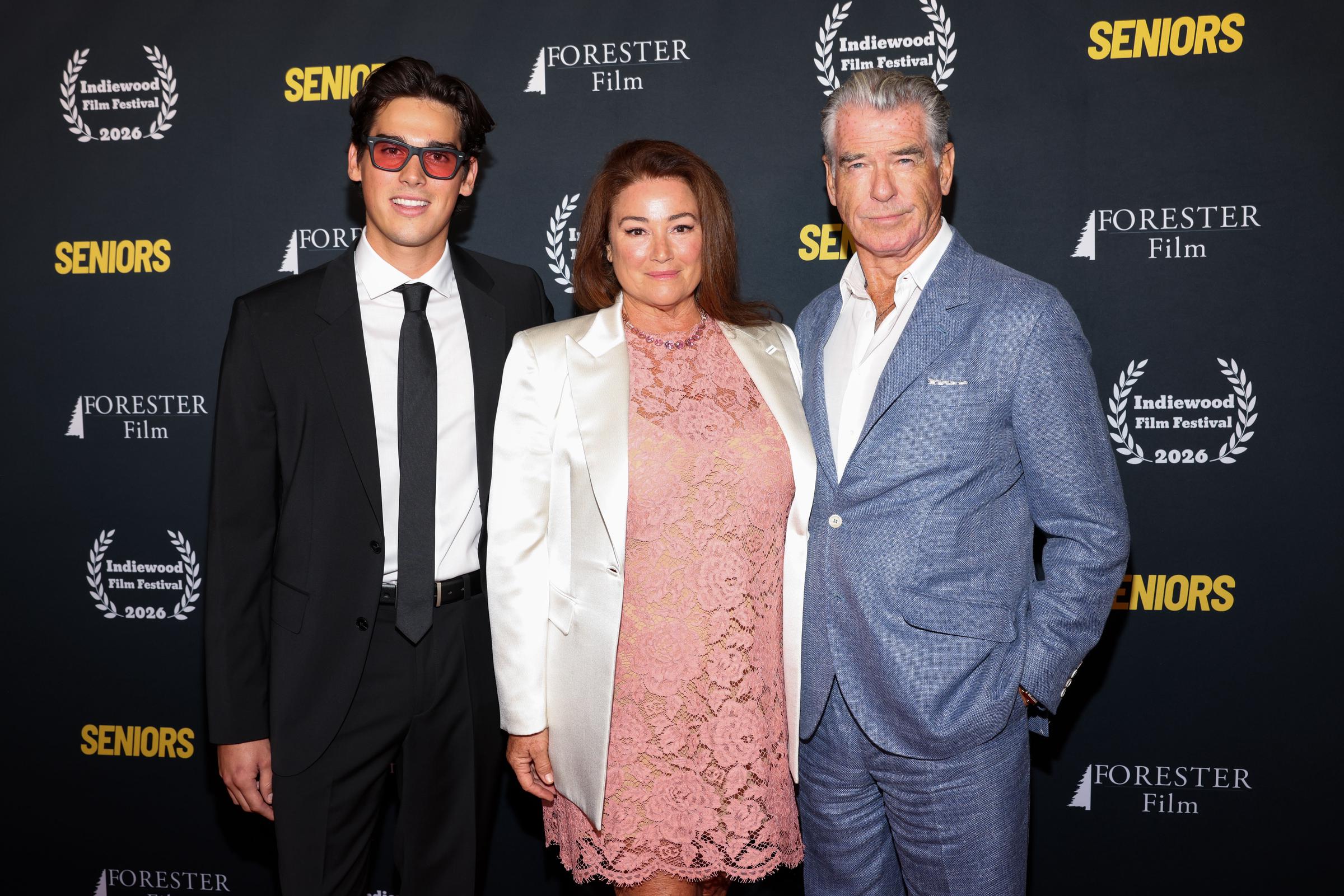 Paris Brosnan joined his parents, Keely Shaye Smith and Pierce Brosnan, for a three-person portrait at the Hollywood screening. Paris stood beside Keely in her pink lace dress and white blazer, while Pierce completed the grouping in his blue linen suit. | Source: Getty Images